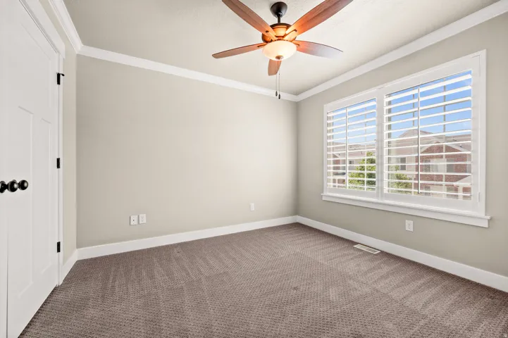 Neutral tone walls complemented by white trim and crown molding