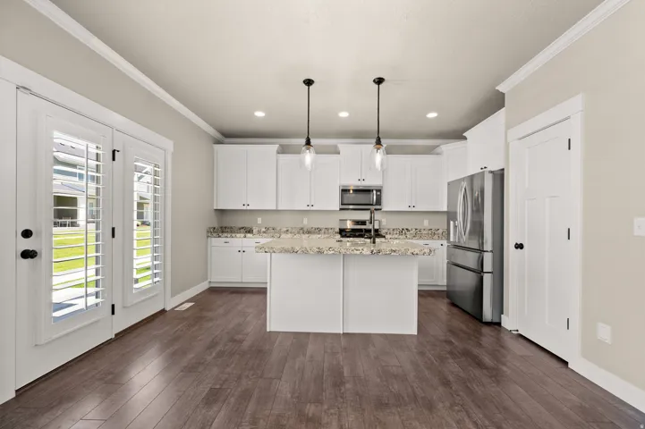 Modern kitchen with white cabinetry and stainless steel appliances