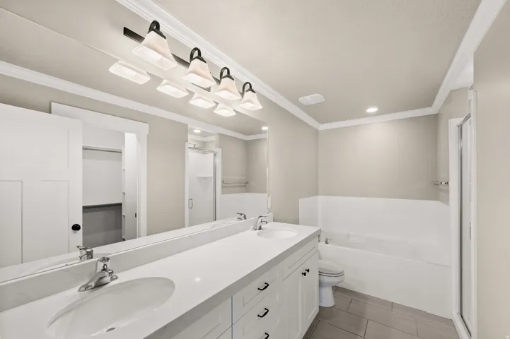Dual vanity with white cabinetry, a light-toned countertop, and undermount sinks