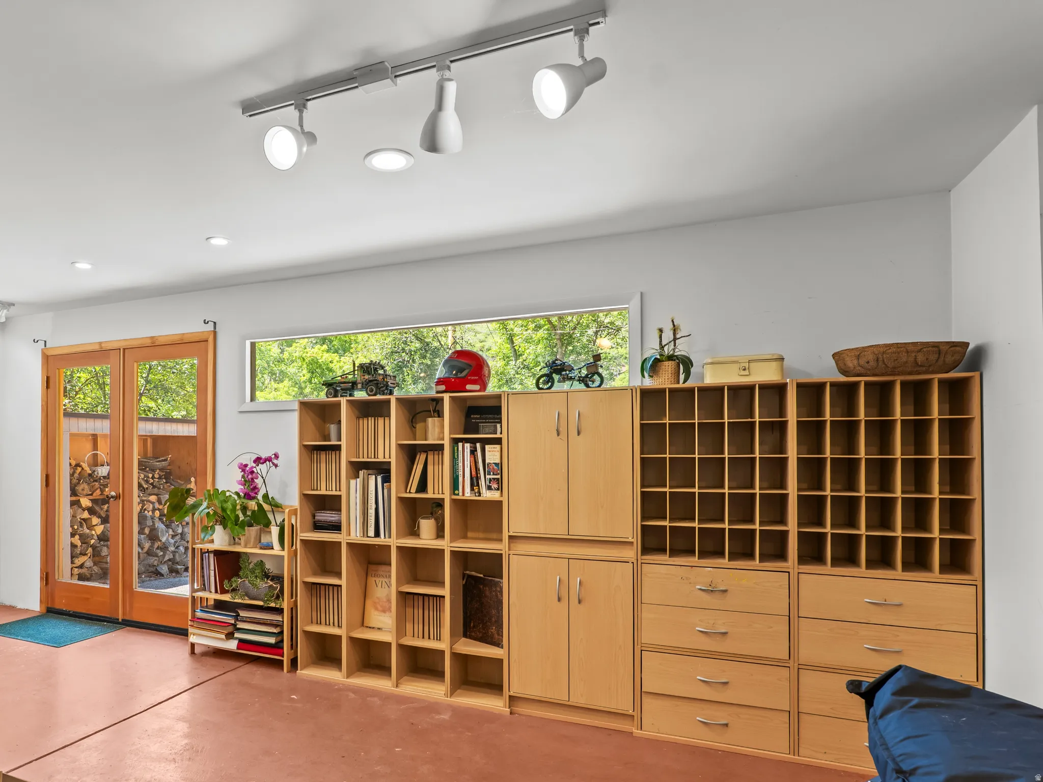 Stand only studio featuring a central wood-burning stove,  and extensive built-in cabinetry with open shelving and drawers