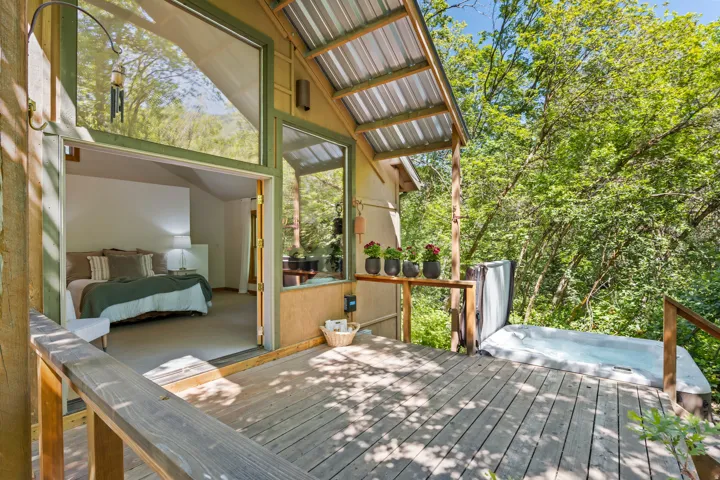 Expansive wood deck with an integrated hot tub right off the master bedroom