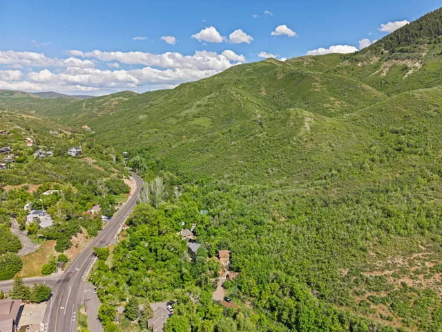 Expansive aerial scene featuring lush green canyon and mountains