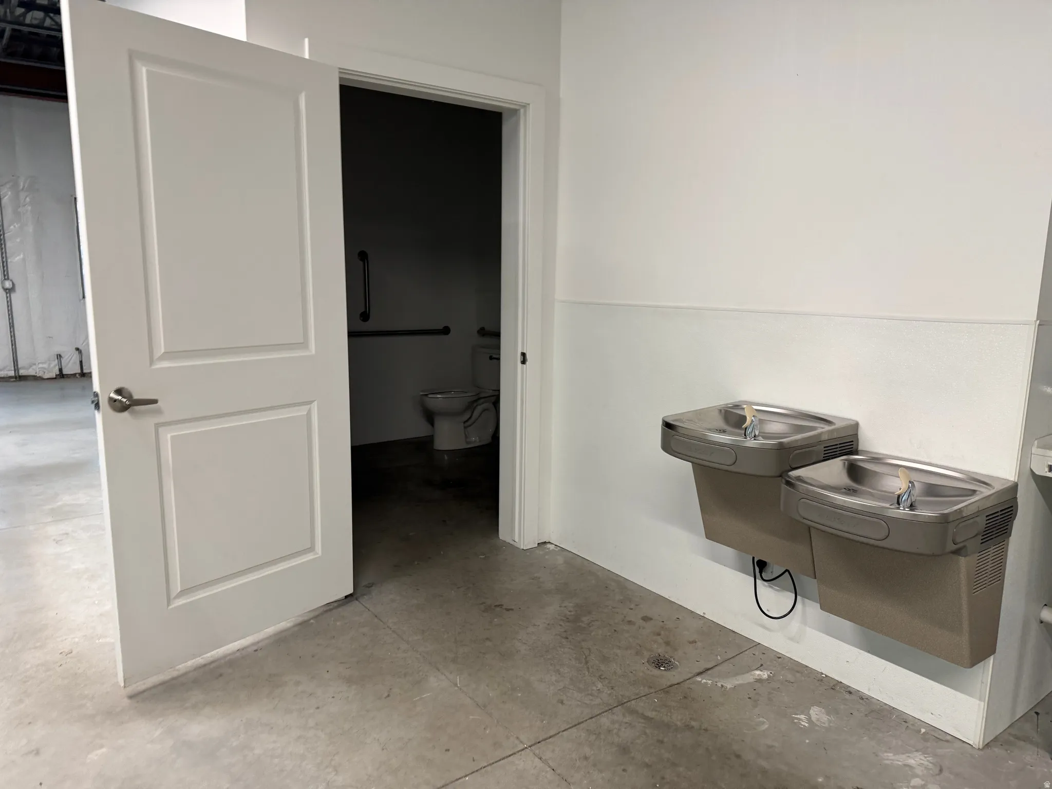 Two wall-mounted drinking fountains with a neutral finish