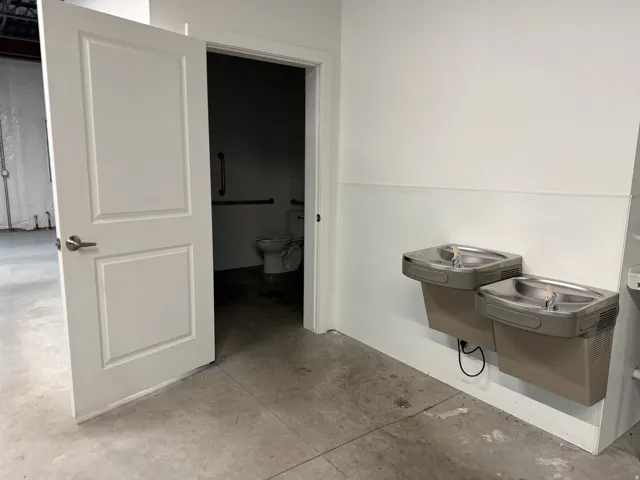 Two wall-mounted drinking fountains with a neutral finish