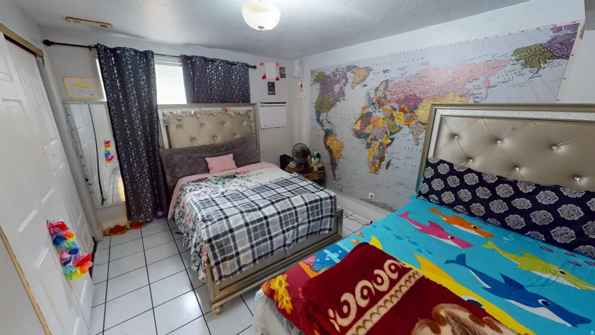 Room featuring tile flooring and a ceiling-mounted light fixture