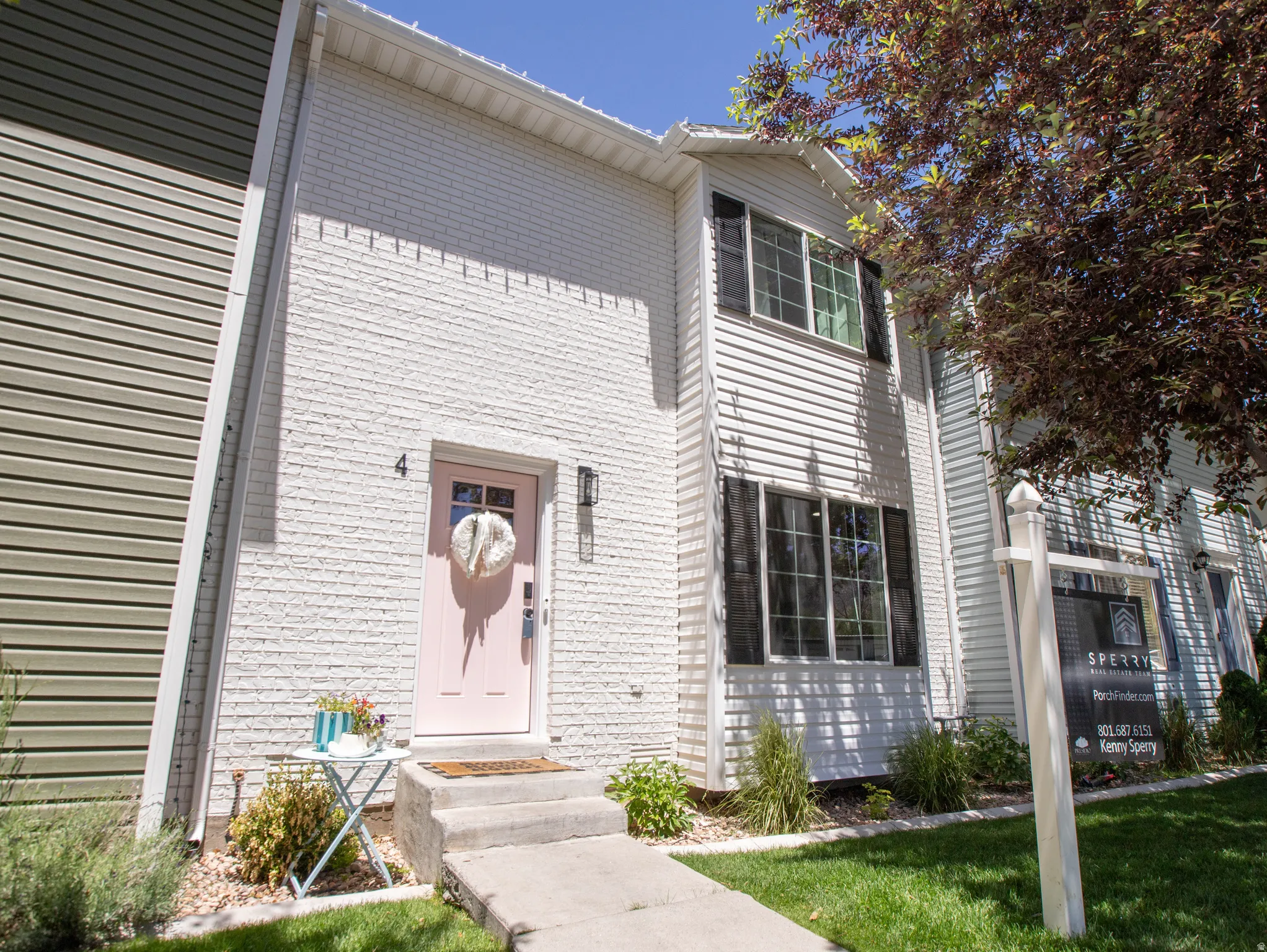 Two-story residence featuring a white brick and siding exterior