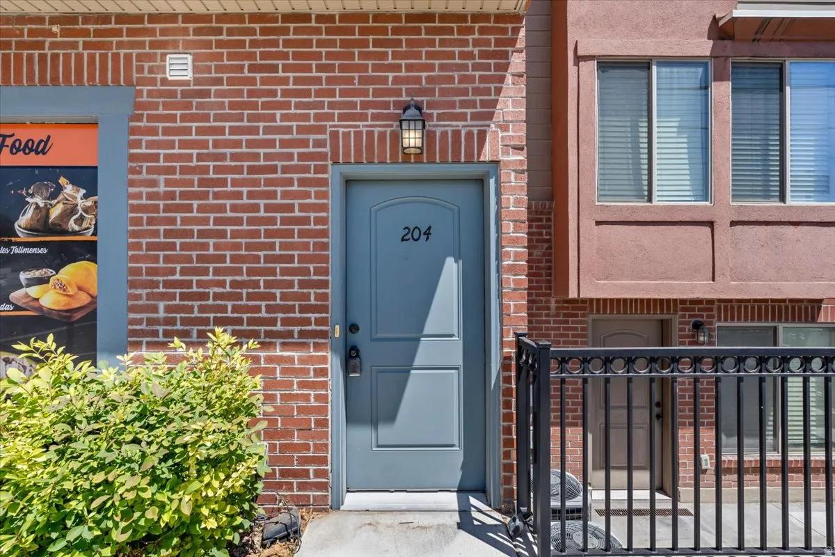 Entry door with number 204, set within a brick facade
