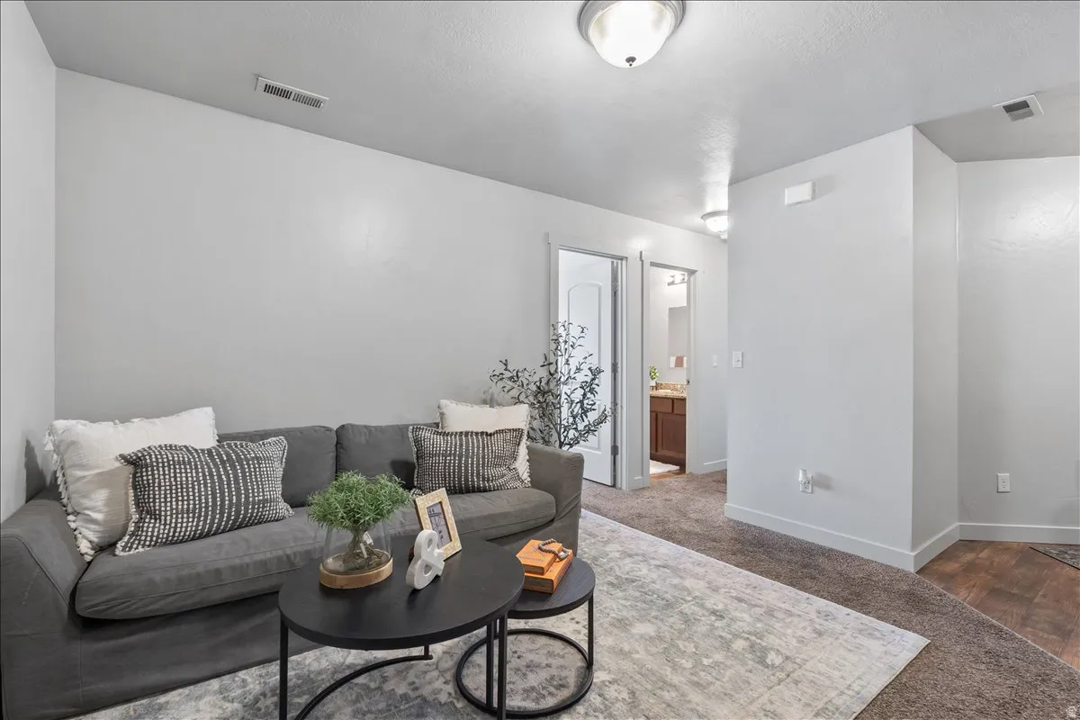 Bright interior space featuring neutral wall tones, recessed lighting, and soft carpet flooring