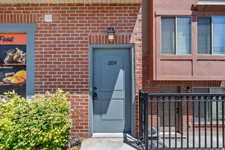 Entry door with number 204, set within a brick facade