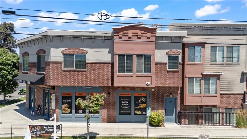 Multi-story building featuring a brick veneer and stucco exterior