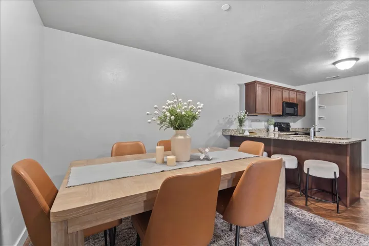 Dining area featuring wood-finish flooring and light gray walls