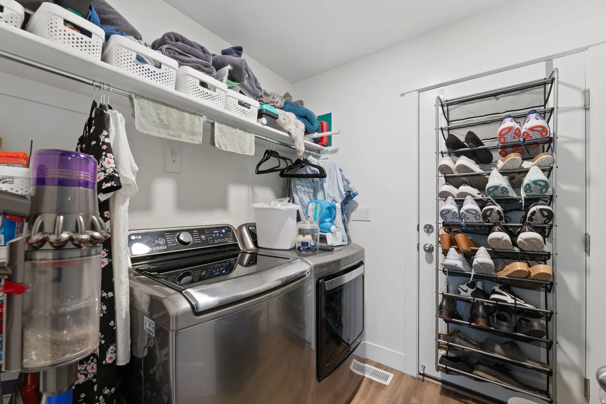 Dedicated laundry space featuring a stainless steel washing machine and dryer