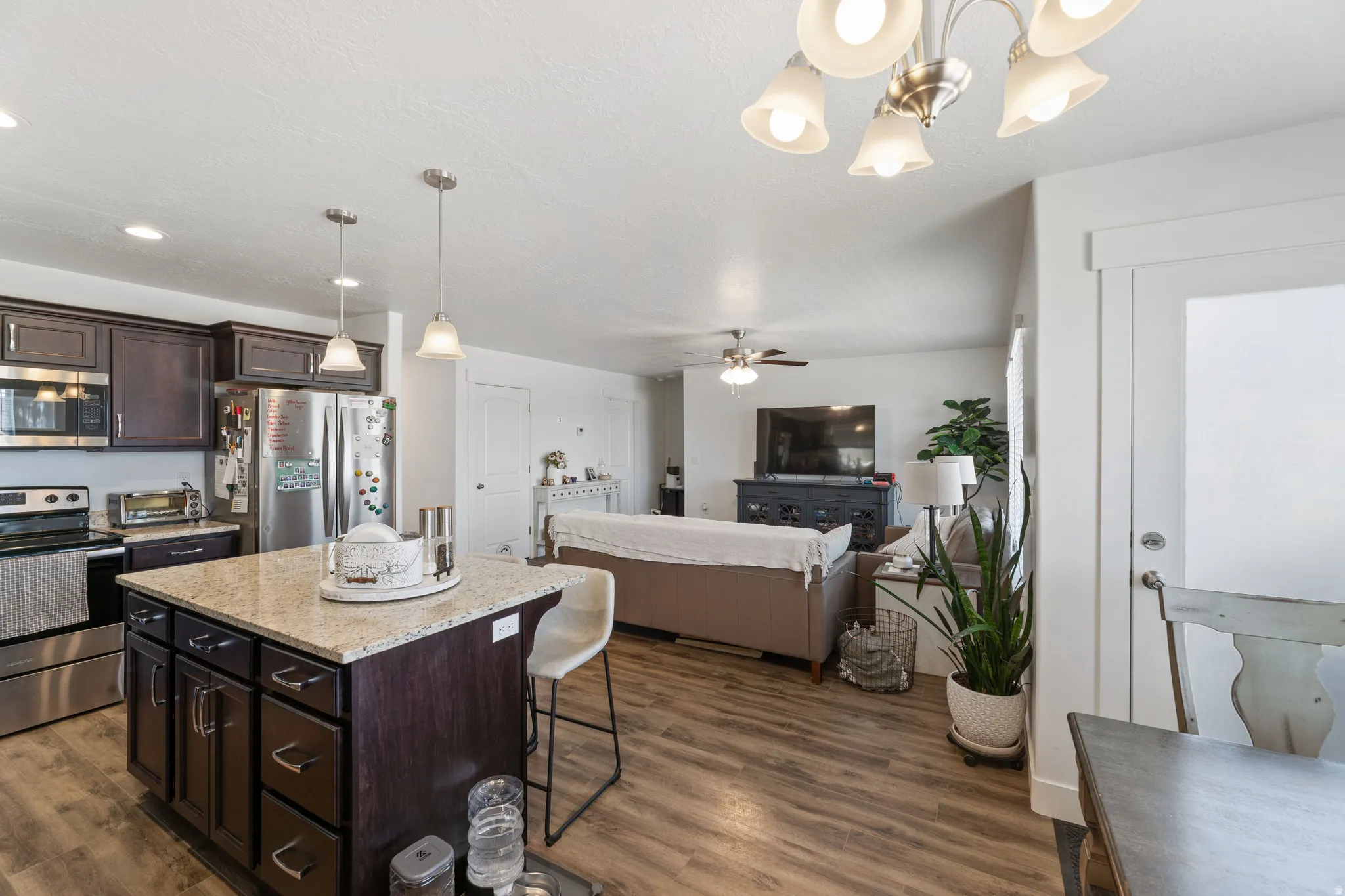 Open-concept living space with wood-finish flooring