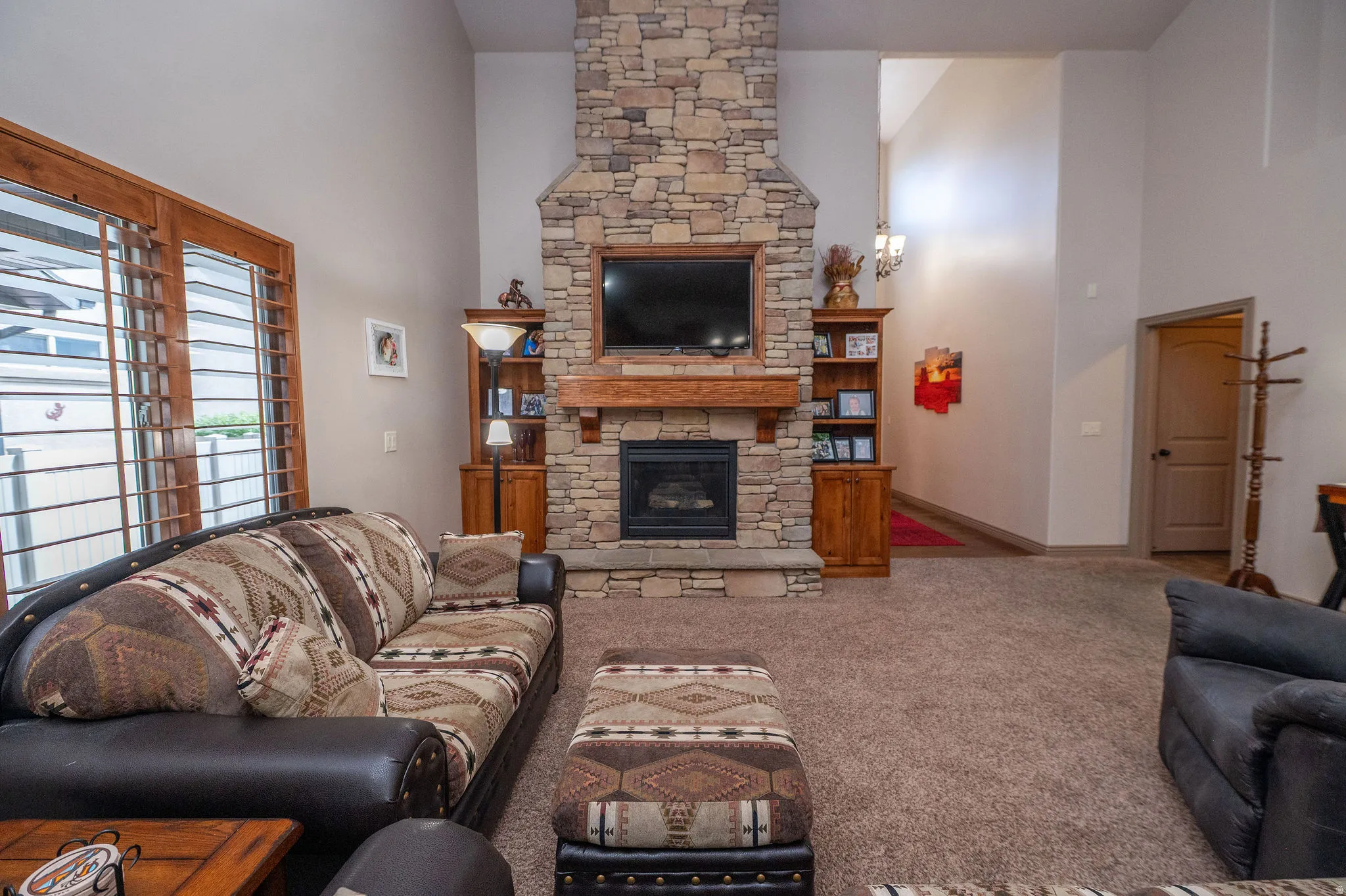 A second look at that gorgeous stacked stone fireplace and the open layout of this vaulted great room. Bright, airy, and built for real living.