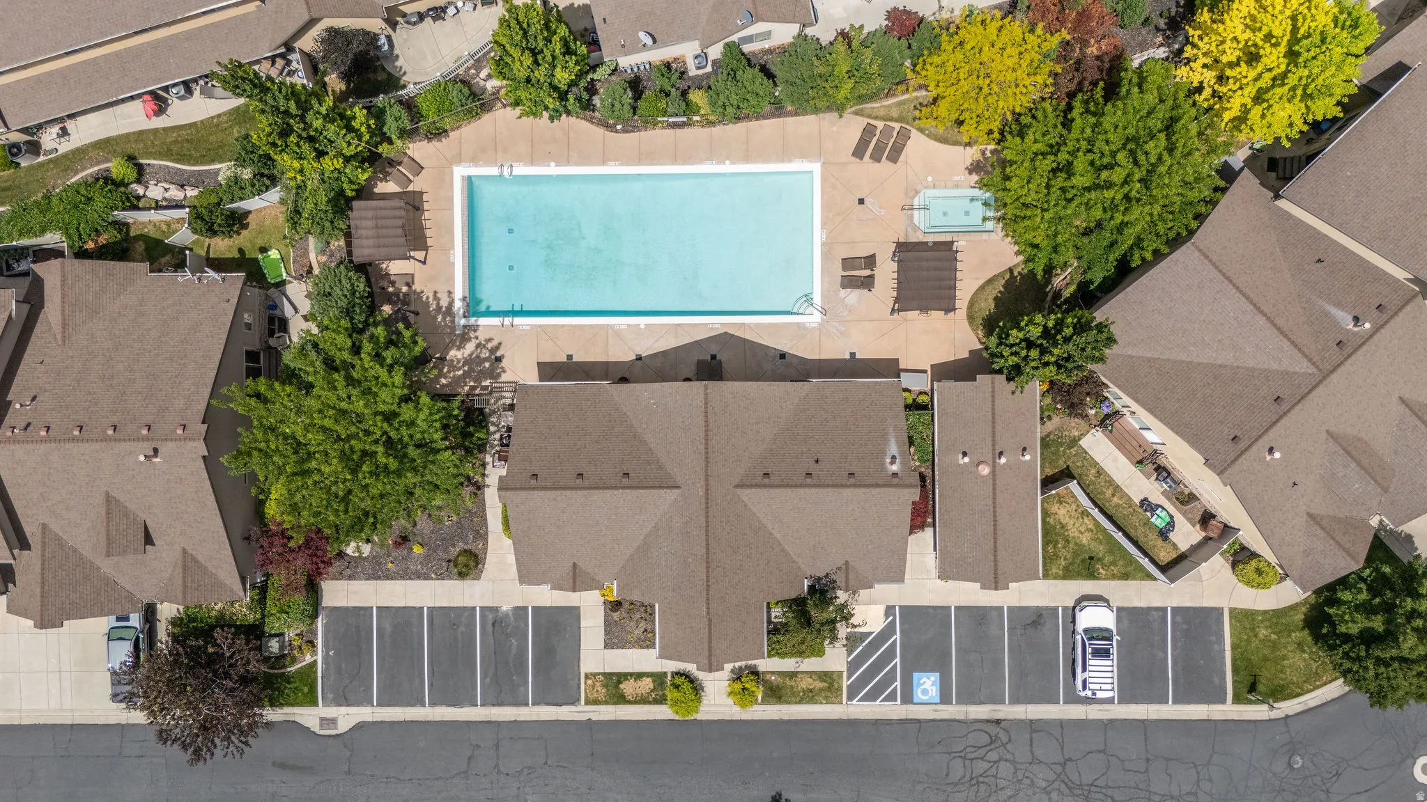 Full-size community pool with spacious sun deck, shade structures, lounge seating, and spa area. Summer living starts right here.
