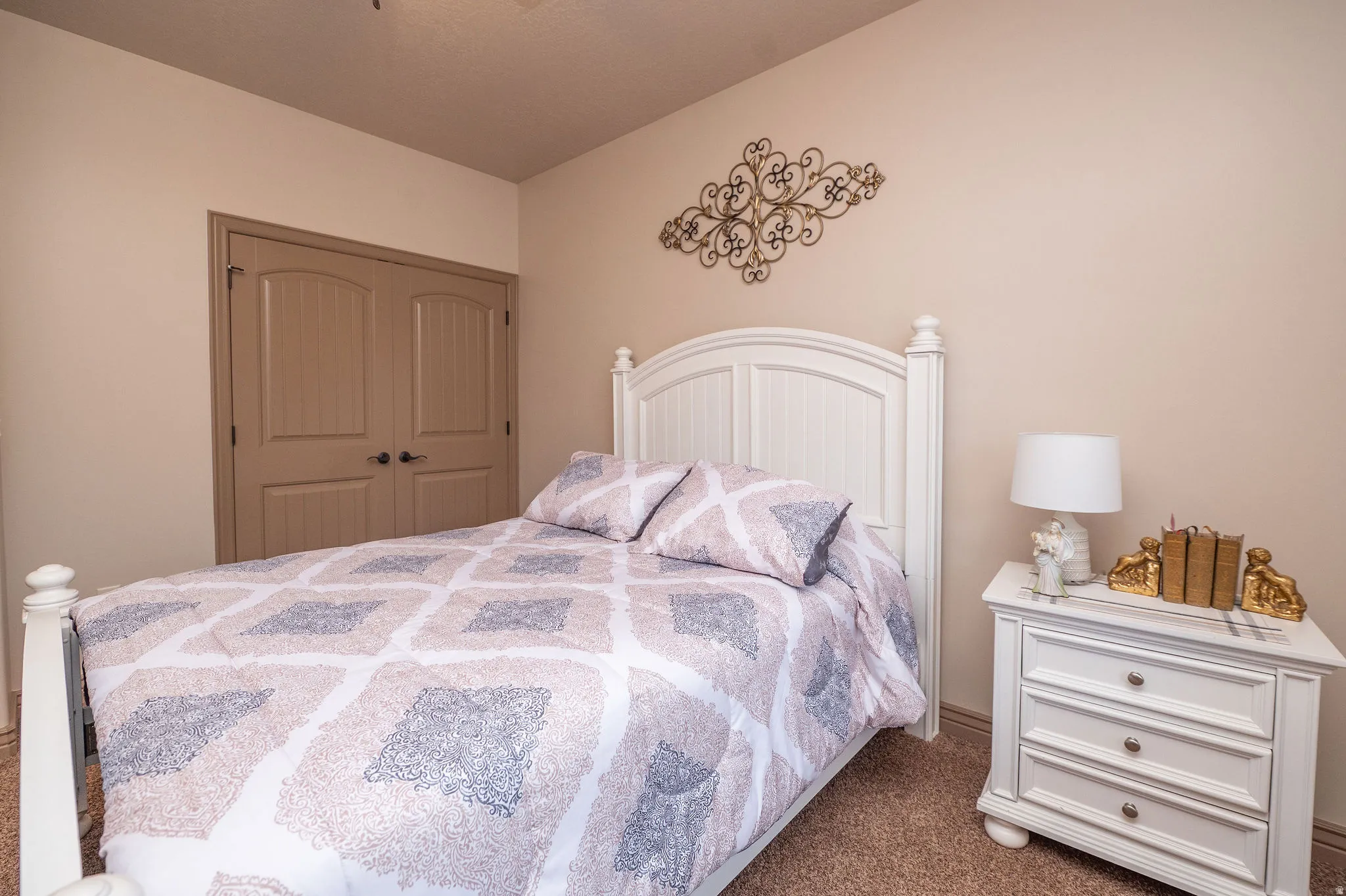 Secondary bedroom showing double closet doors and cozy carpet. A warm, welcoming space ready to make its own.