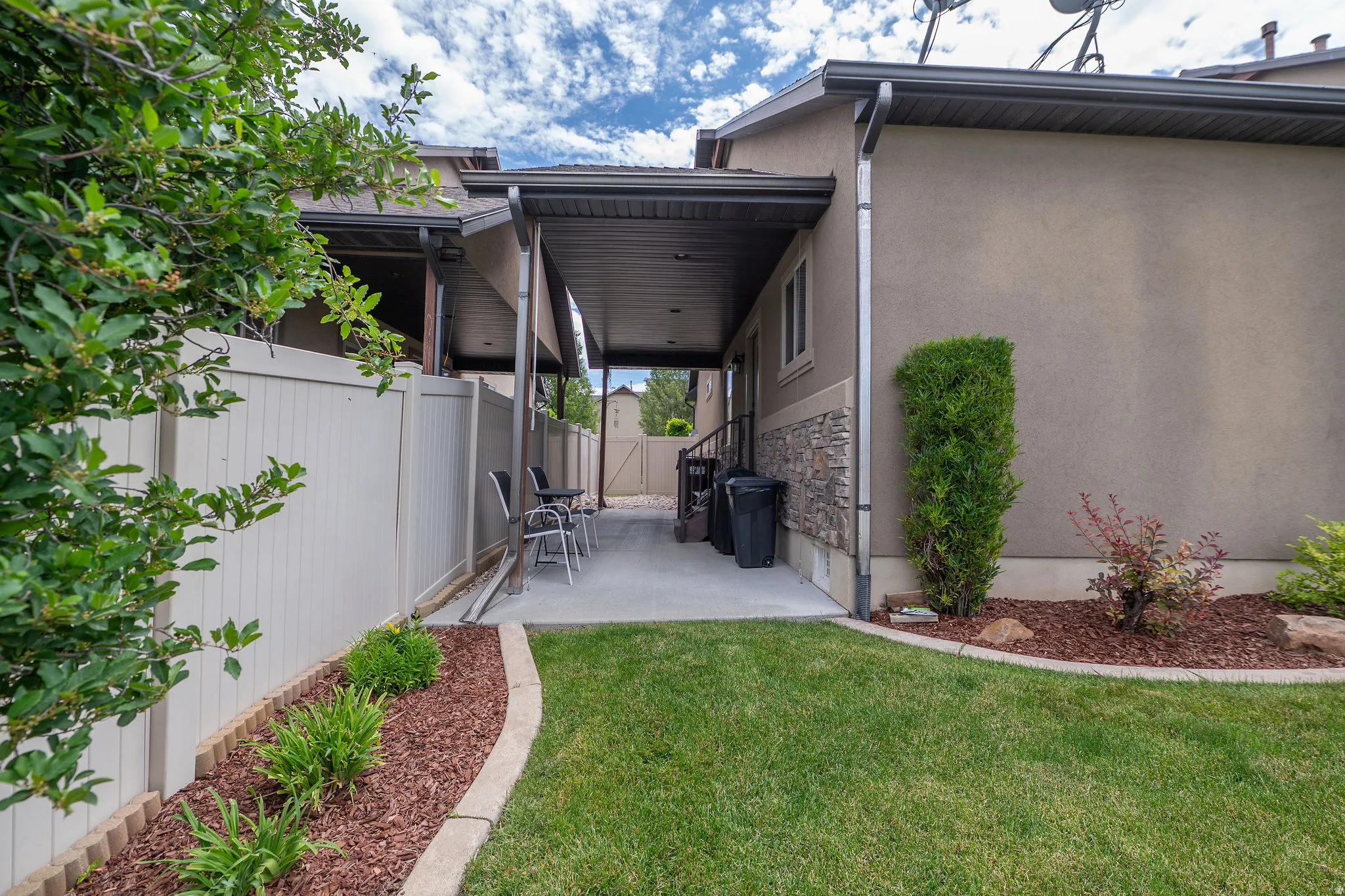 Generous covered patio with finished ceiling, open to the backyard and ready for entertaining. Fully Landscaped borders.
