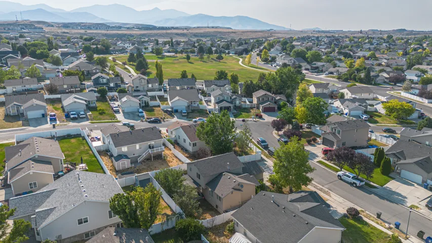 Residential neighborhood featuring single-family homes with pitched roofs and attached garages