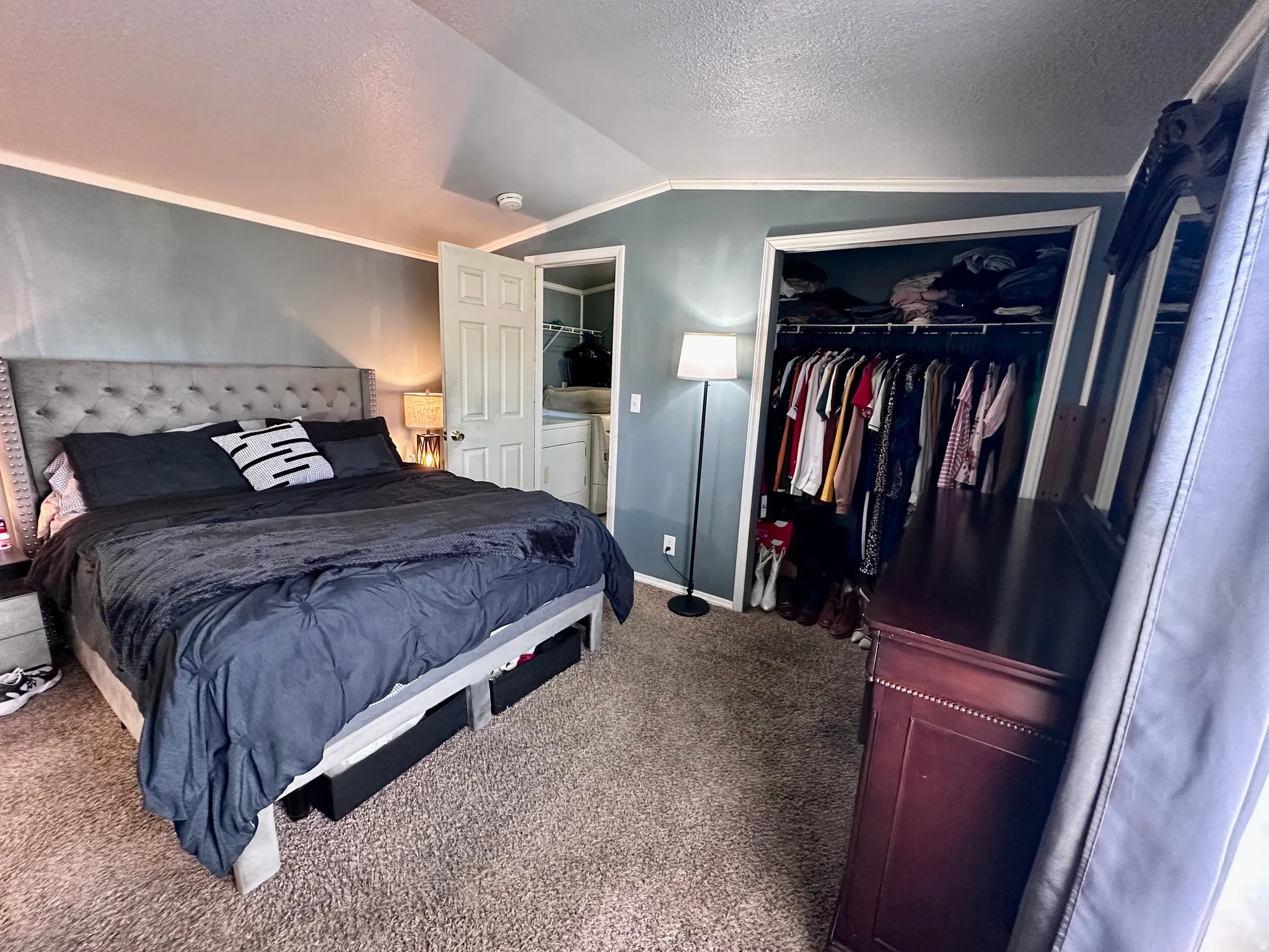Plush carpeted flooring complementing a built-in closet with shelving and hanging rods