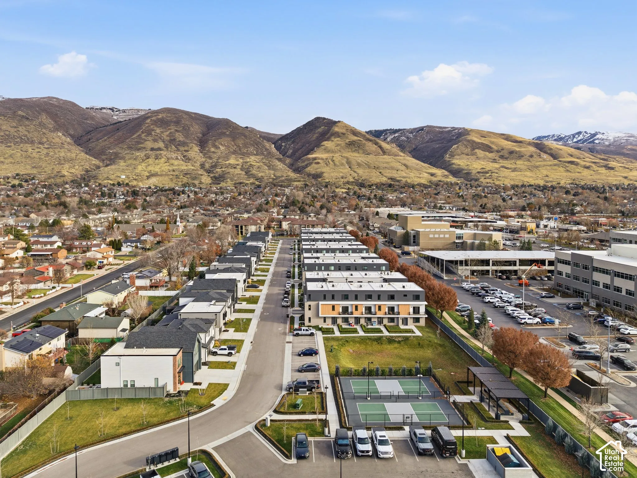 Modern townhouse development featuring organized rows of residences with flat roofs and varying facade treatments