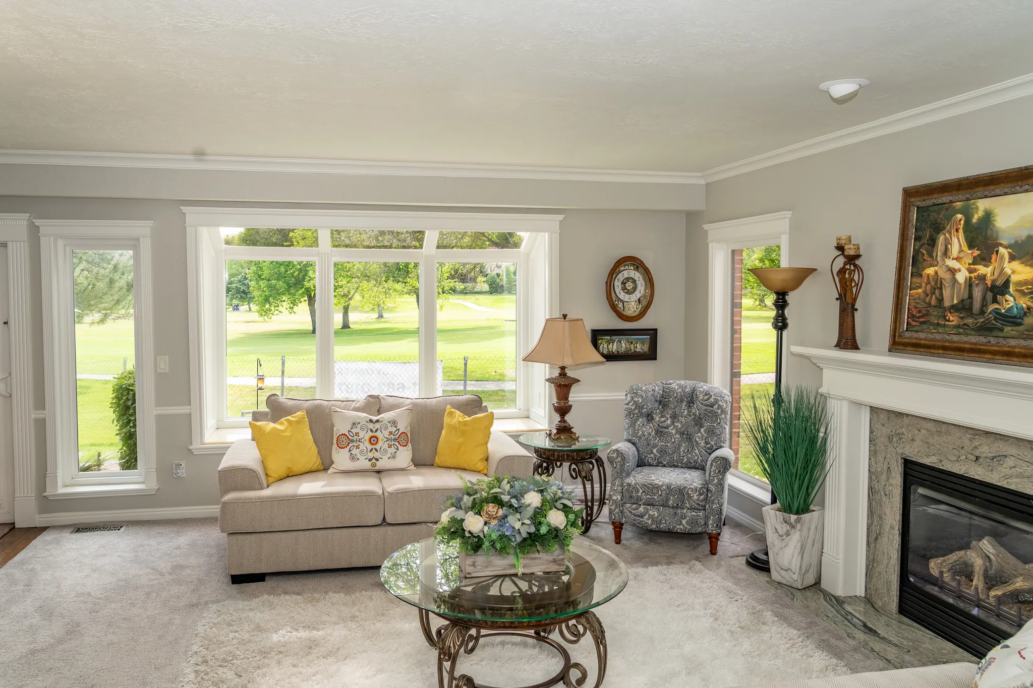 Living area featuring a prominent window wall overlooking a green landscape