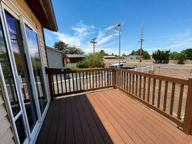 Expansive exterior deck featuring composite decking and a wood railing system