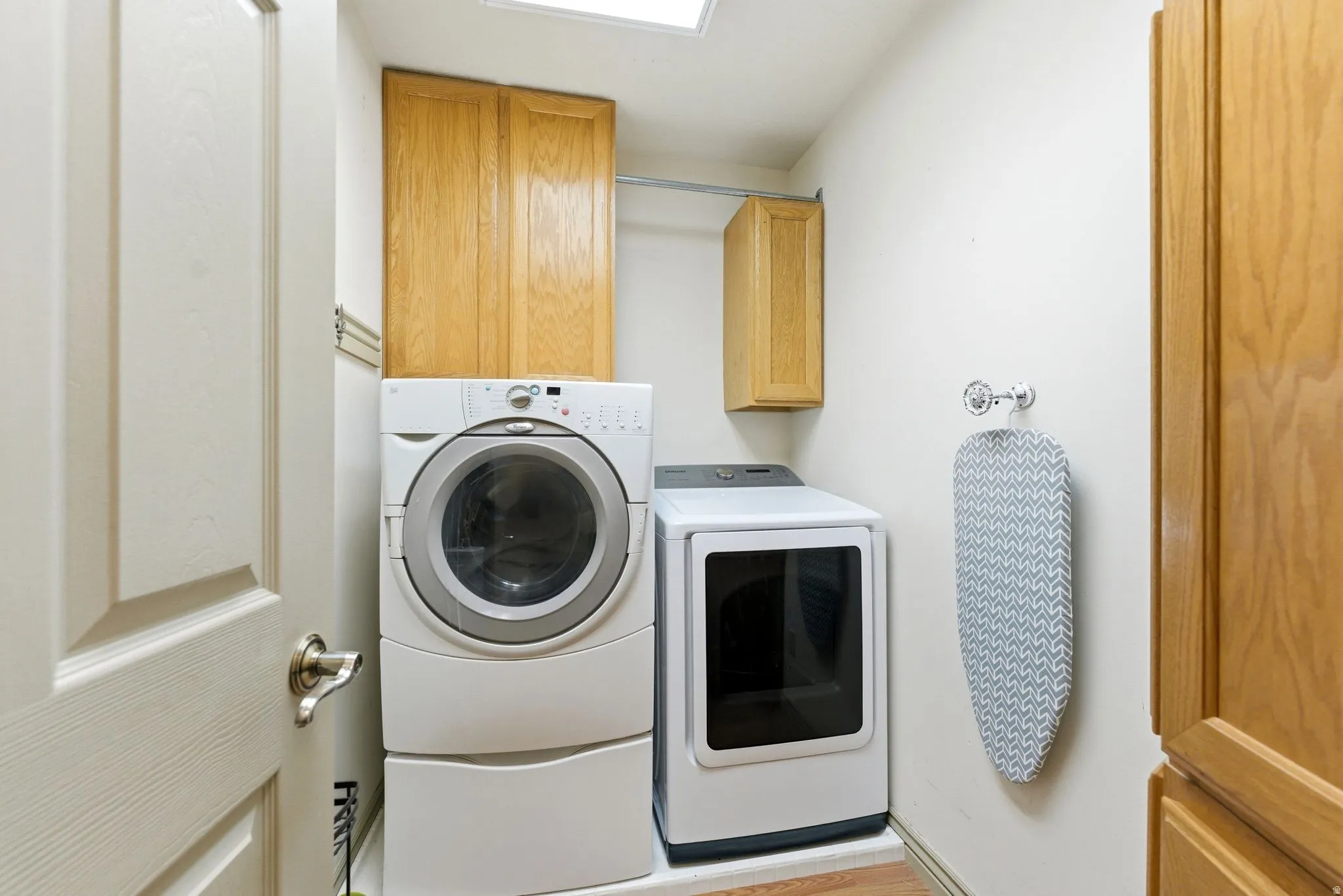 Dedicated laundry space featuring a white front-loading washer and dryer set