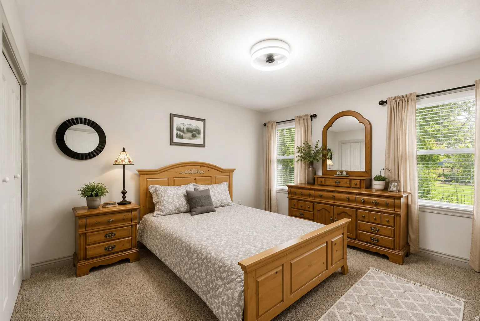 Carpeted bedroom with neutral wall paint and white trim