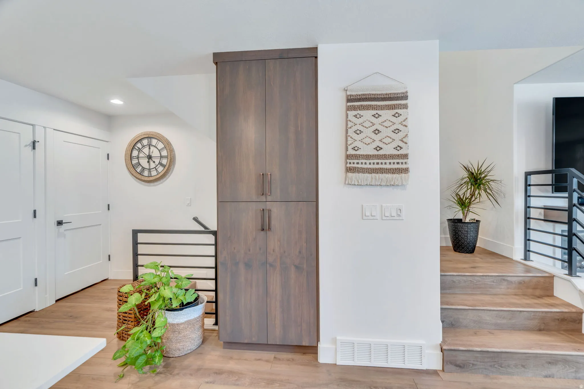 Entryway with light wood-style floors and recessed lighting