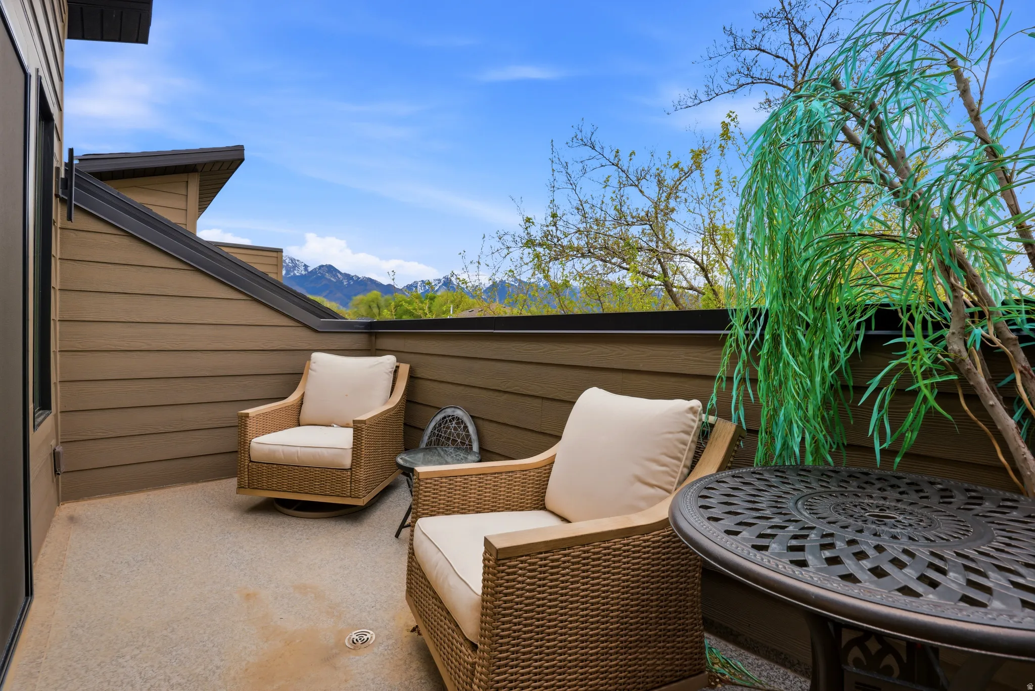 Private outdoor balcony featuring composite decking and mountain scenery