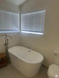 Freestanding soaking tub with floor-mounted faucet