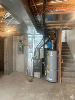 Basement utility area featuring exposed concrete walls and flooring