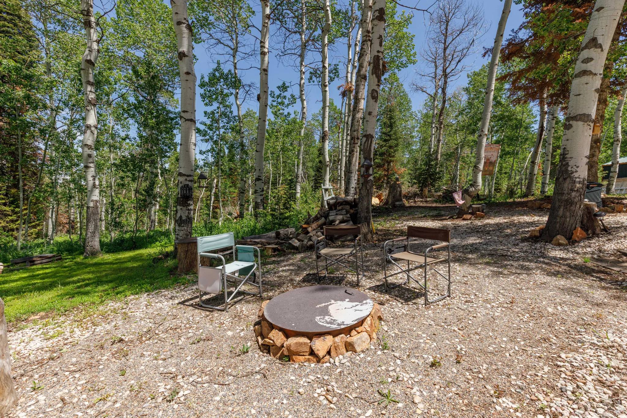 Outdoor fire pit area featuring a stone surround and metal grate