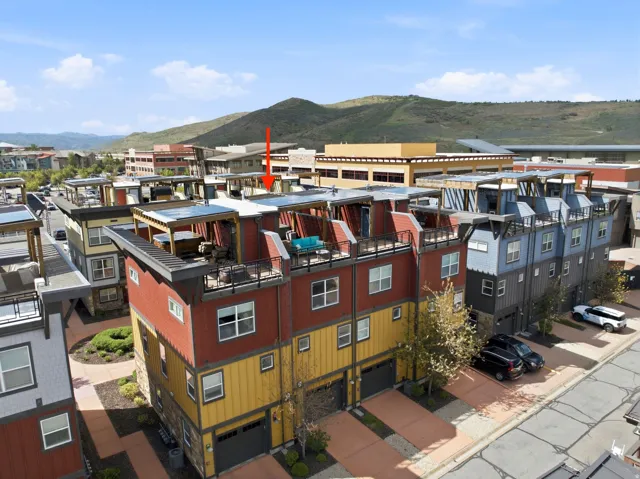 Contemporary townhome featuring a private rooftop deck, attached garage, and multi-level design