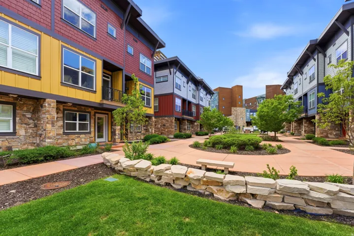 Modern exterior architecture featuring a stone base and colorful siding