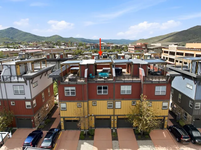 Multi-level townhome featuring a rooftop deck