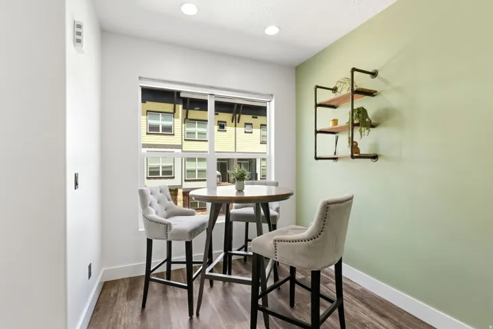 Hardwood-finish flooring complements the interior with a light green accent wall