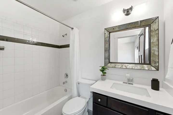 Bathroom featuring a dark wood-finish vanity with a white countertop and integrated sink