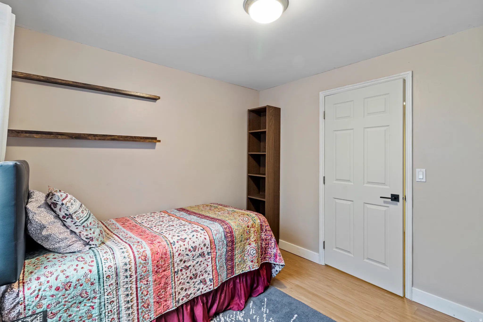 Hardwood-finish flooring complements neutral wall tones and white baseboards