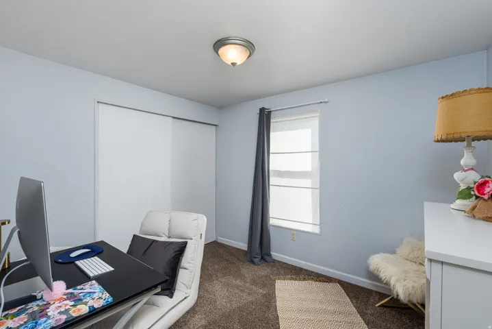 Light blue walls complement the brown carpeted flooring