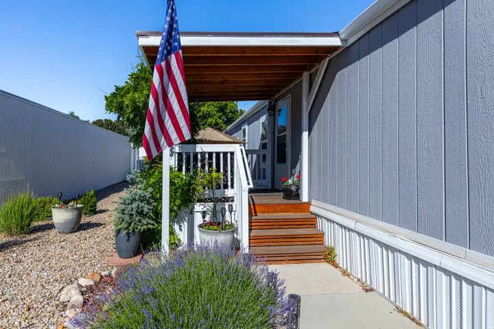 Inviting covered porch with a wood-finish ceiling and privacy railing