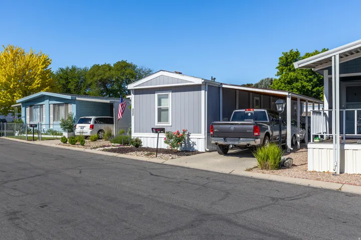 Manufactured home featuring light gray siding with white trim