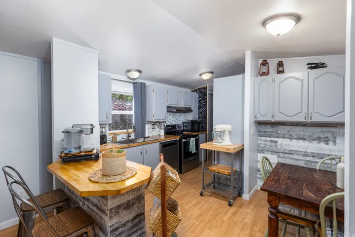 Kitchen featuring light wood-finish flooring and grey cabinetry