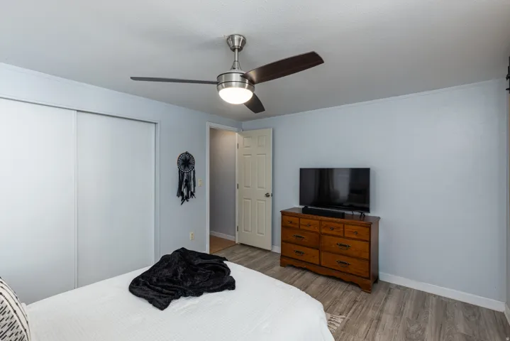 Room featuring wood-finish flooring and light blue wall paint