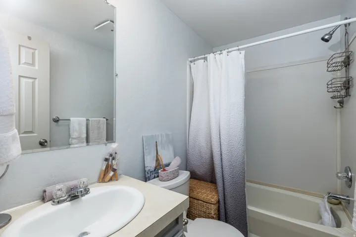 Bathroom featuring a vanity with a white oval sink, chrome faucet, and a large wall-mounted mirror