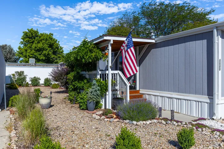 Entryway featuring a covered porch with wooden steps and white railings