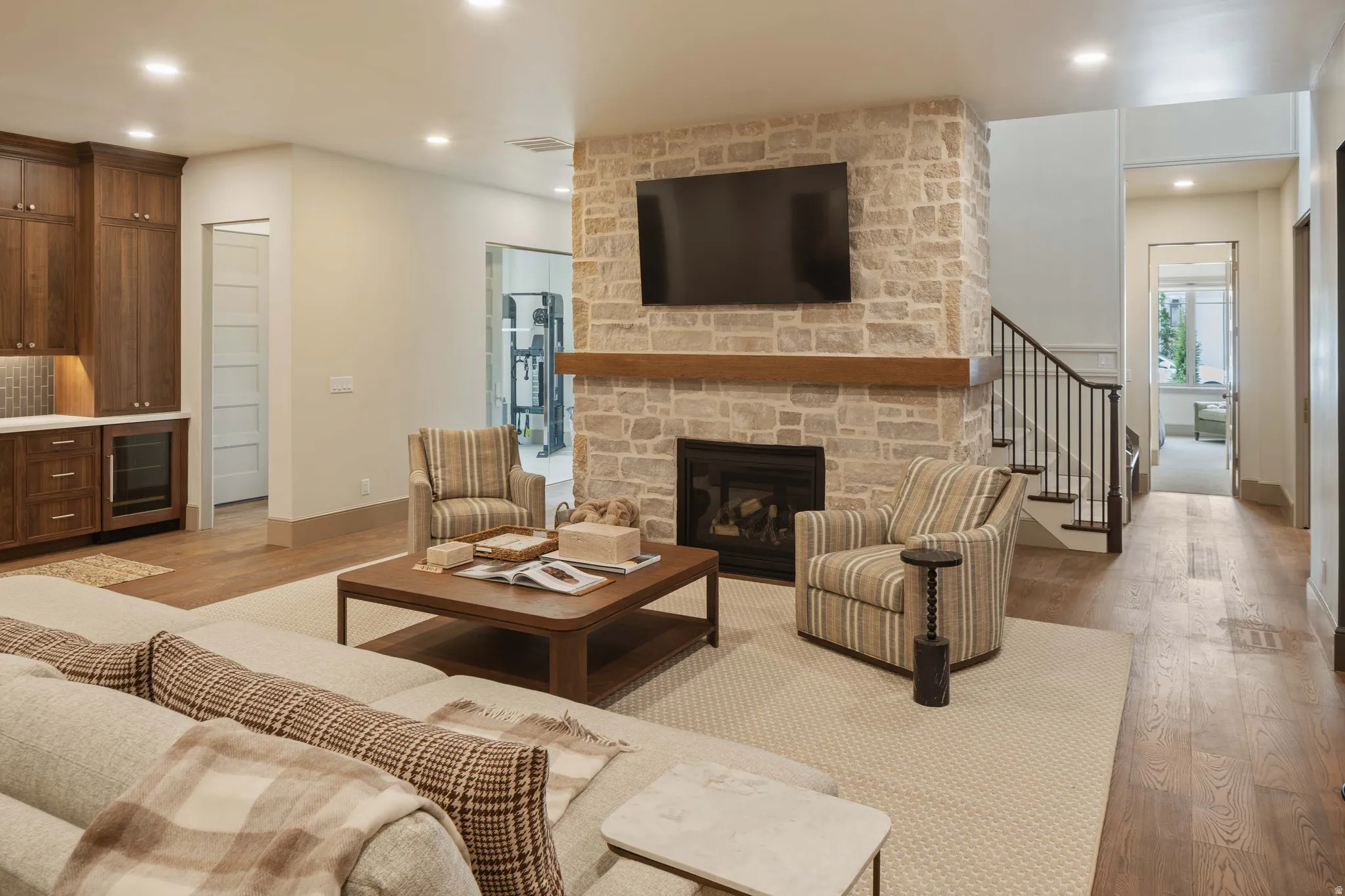 Stone-clad fireplace with a wood mantel