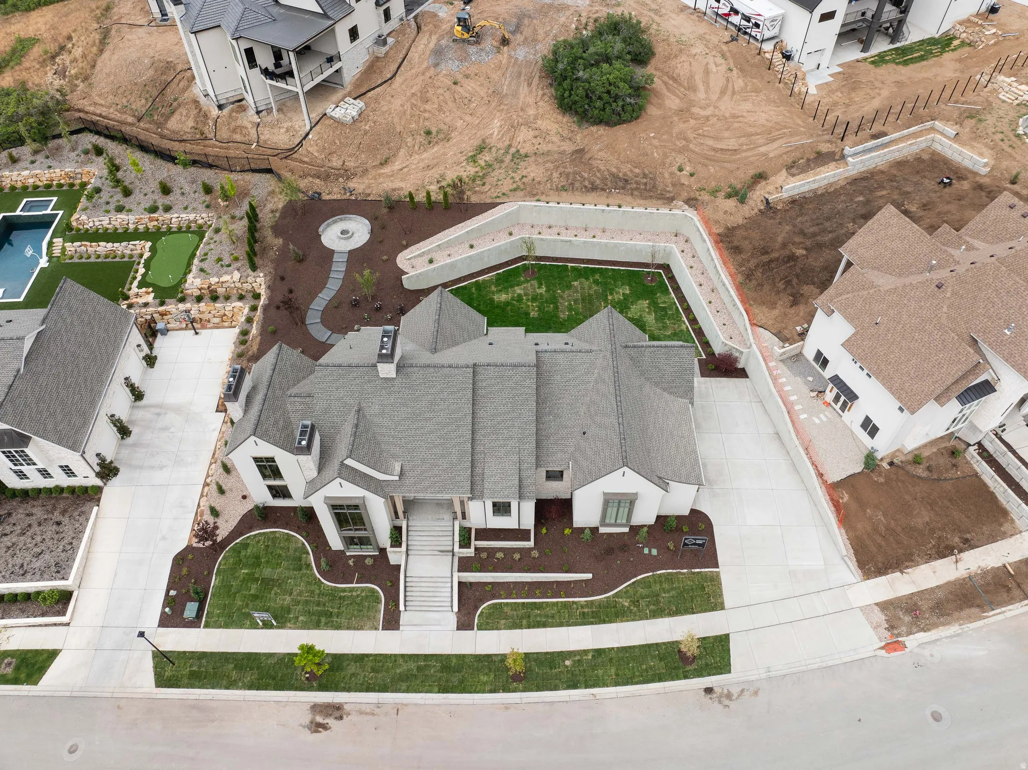 Contemporary residence featuring a multi-gabled roofline and a light-toned exterior