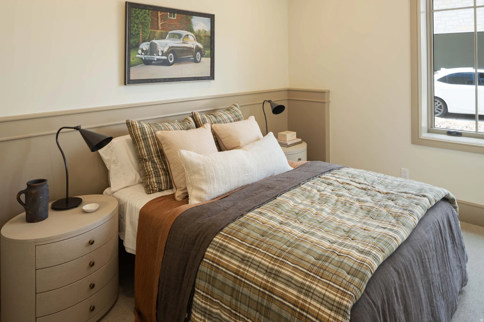 Neutral bedroom featuring light-colored walls and wainscoting