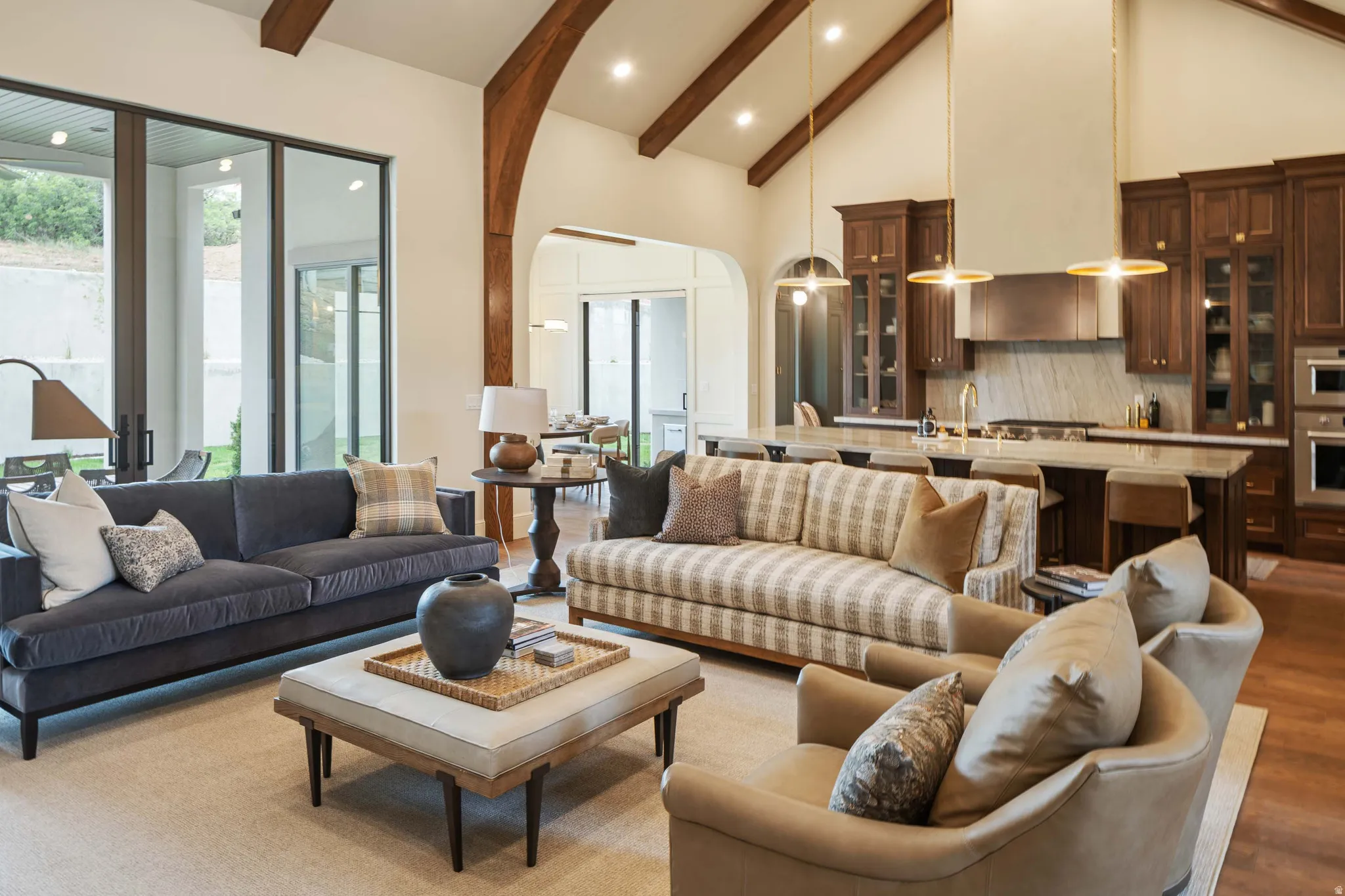 Expansive living area with vaulted ceilings and exposed wood beams
